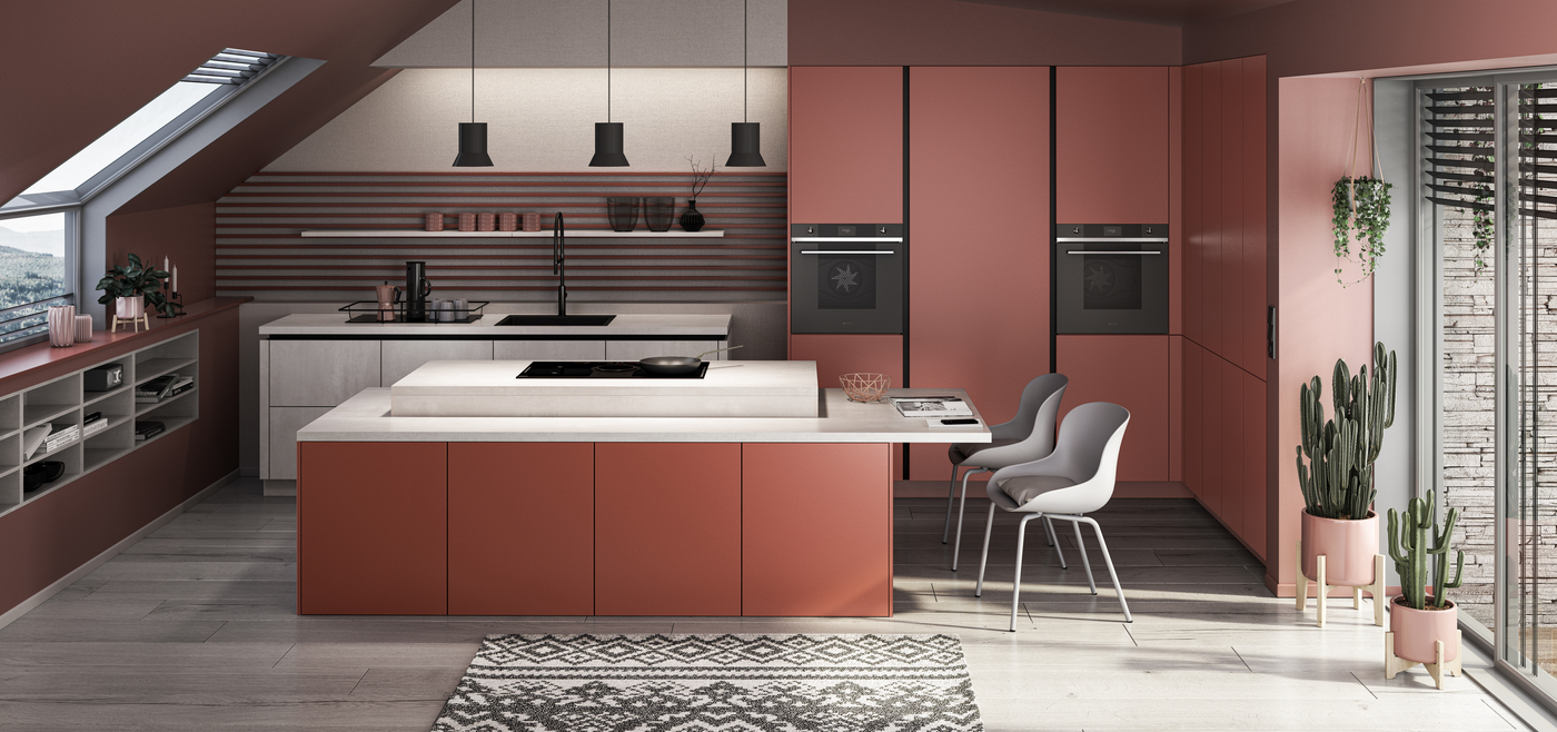 Moderne Küche mit rosafarbenen Fronten, zwei weißen Stühlen und großen Kakteen